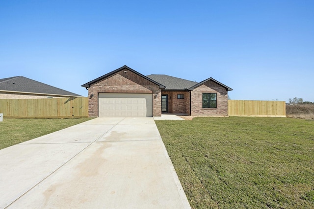 view of front of house featuring a front yard and a garage