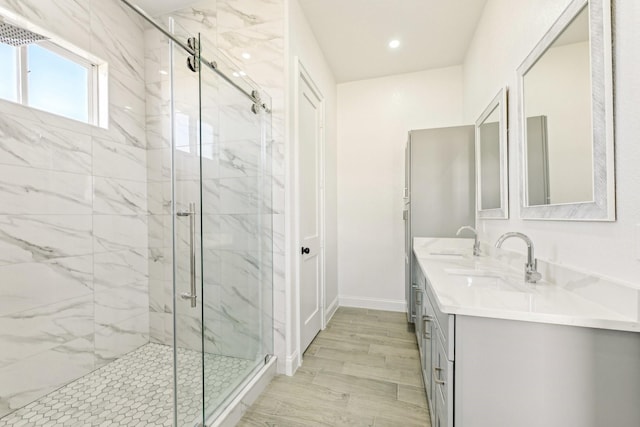 bathroom featuring vanity and a shower with shower door