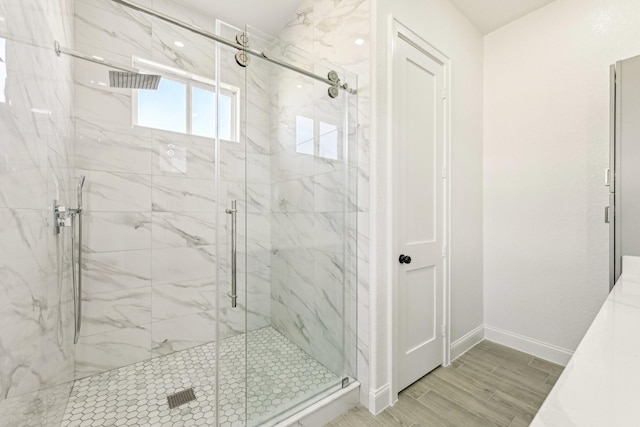 bathroom featuring a shower with shower door