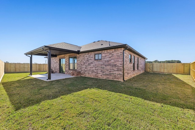 back of property with a patio area and a yard