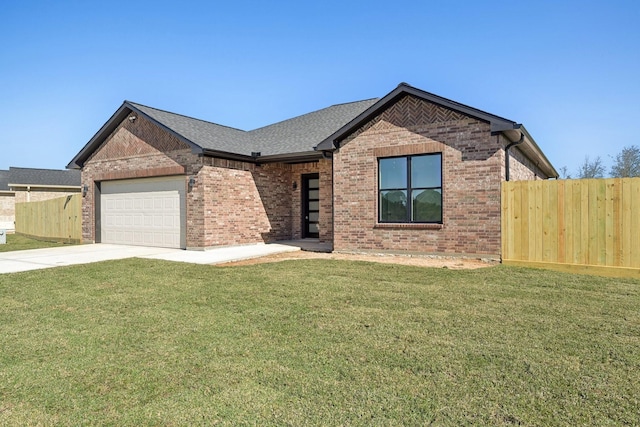 view of front of house featuring a front yard and a garage