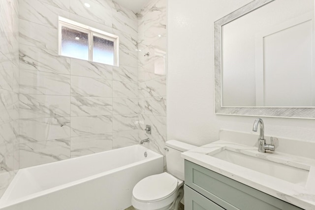 full bathroom featuring tiled shower / bath, vanity, and toilet