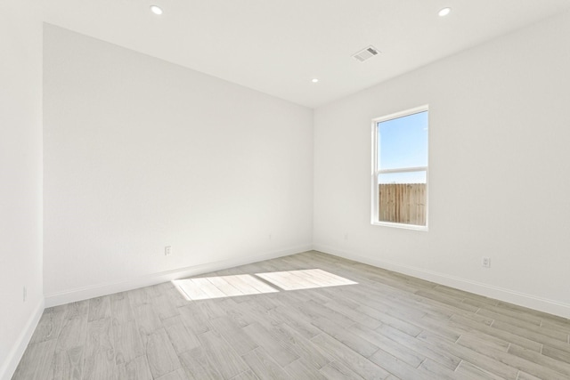 unfurnished room with light wood-type flooring