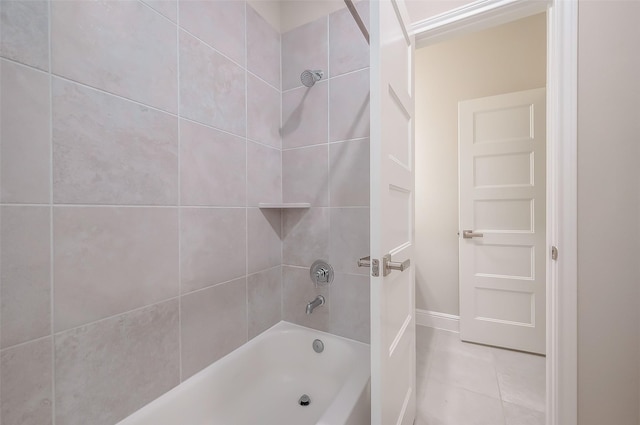 bathroom featuring tile patterned flooring and tiled shower / bath