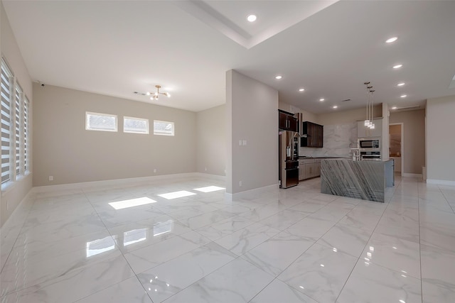 unfurnished living room featuring sink