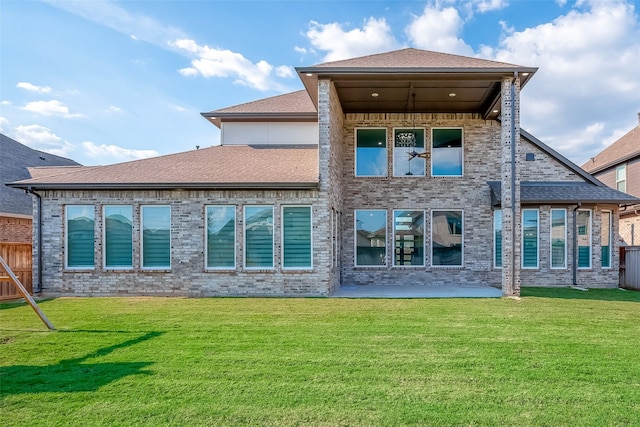 rear view of property with a yard and a patio