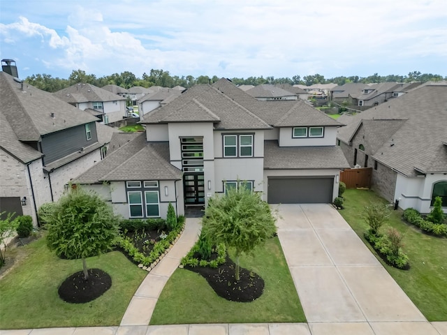 view of front of home with a front lawn and a garage