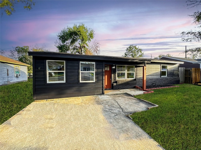 ranch-style home with a yard