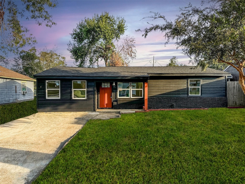 ranch-style house with a yard