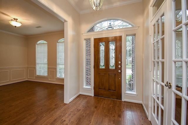 foyer featuring crown molding, dark hardwood / wood-style floors, and french doors