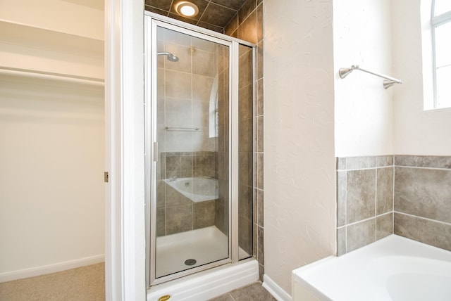 bathroom featuring independent shower and bath