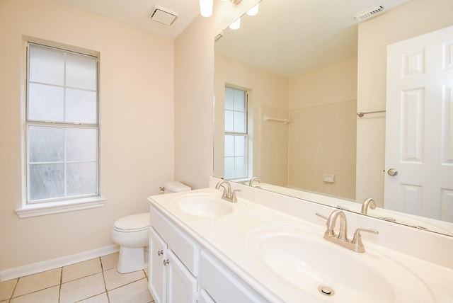 bathroom with vanity, plenty of natural light, tile patterned floors, and toilet