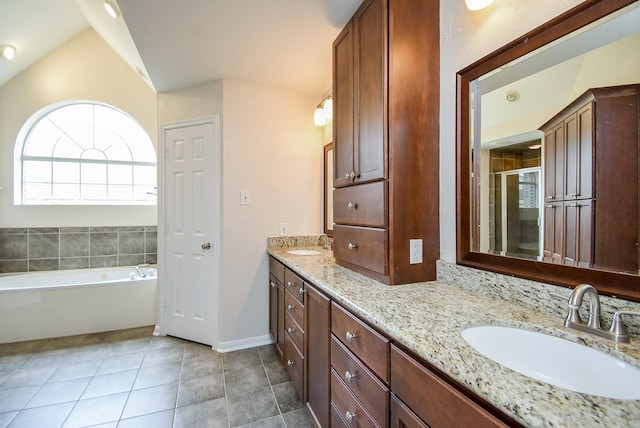 bathroom with lofted ceiling, vanity, tile patterned flooring, and shower with separate bathtub