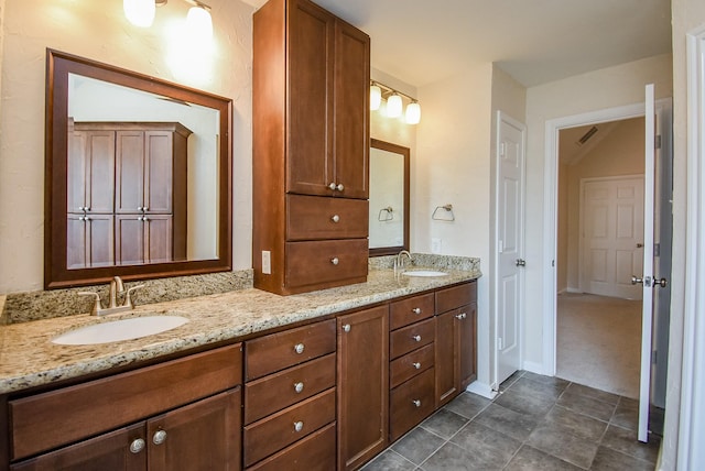 bathroom with tile patterned floors and vanity