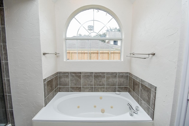 bathroom with a tub to relax in