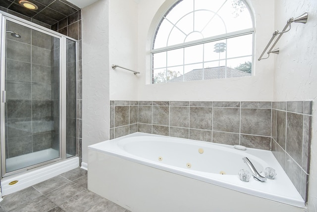 bathroom featuring tile patterned flooring, separate shower and tub, and a wealth of natural light