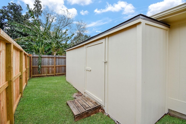 view of outbuilding with a yard