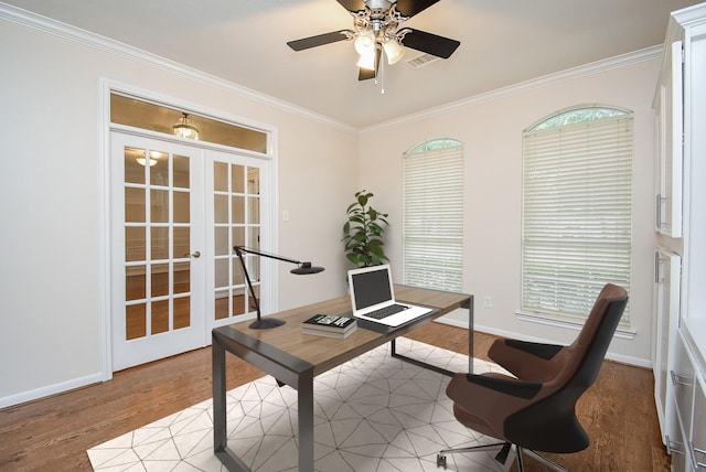 office space featuring french doors, ceiling fan, ornamental molding, and light wood-type flooring