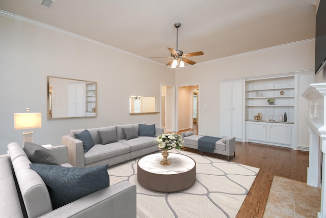 living room with hardwood / wood-style floors, crown molding, and ceiling fan