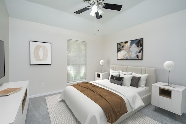 bedroom featuring a raised ceiling, light colored carpet, and ceiling fan