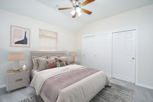 carpeted bedroom featuring vaulted ceiling, a closet, and ceiling fan