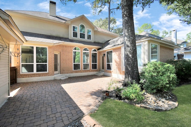 rear view of house featuring a patio