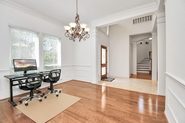 office space with a chandelier, hardwood / wood-style flooring, and crown molding