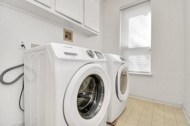 laundry room featuring electric dryer hookup and cabinets