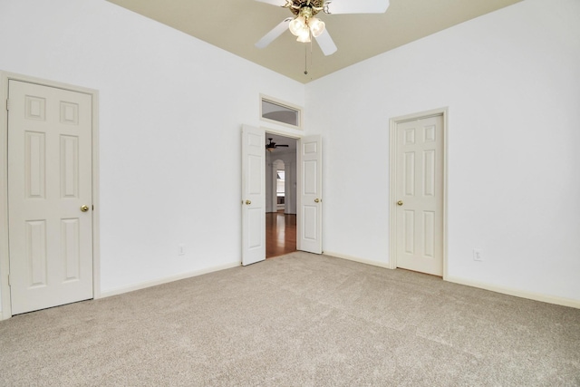 unfurnished bedroom featuring ceiling fan and light colored carpet