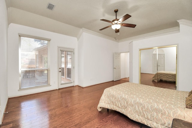 bedroom featuring access to outside, ceiling fan, dark hardwood / wood-style flooring, and crown molding