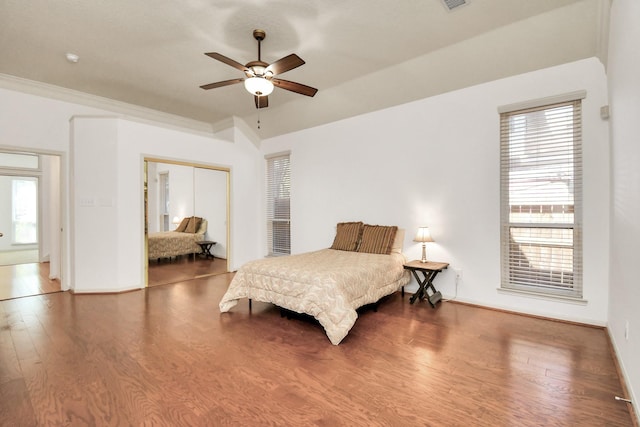 bedroom with ceiling fan, a closet, and hardwood / wood-style flooring