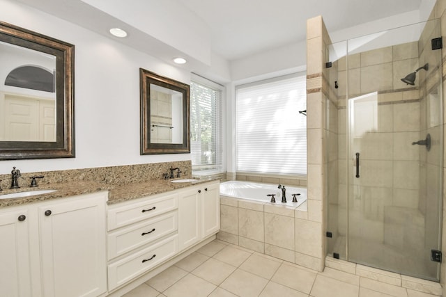 bathroom featuring tile patterned flooring, vanity, and separate shower and tub