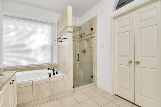 bathroom featuring tile patterned flooring, vanity, and independent shower and bath