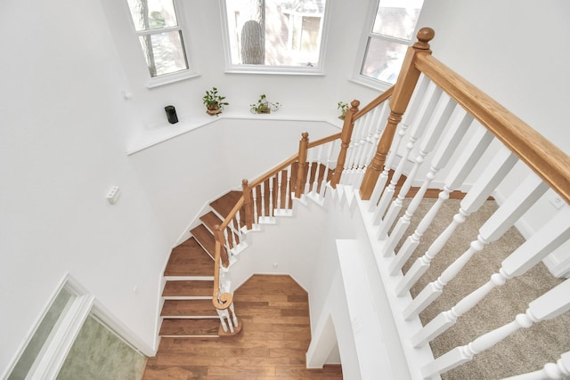 stairs with hardwood / wood-style flooring and plenty of natural light