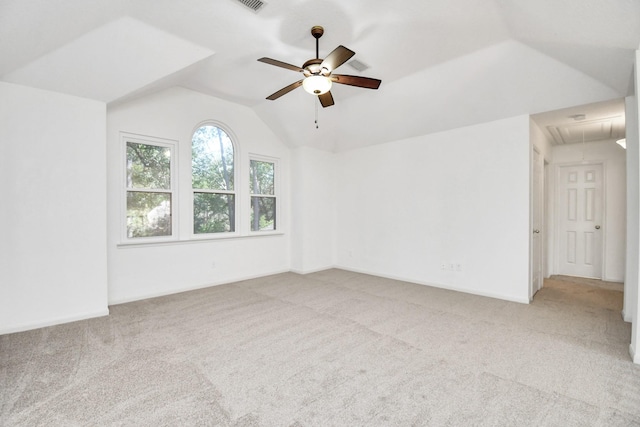 carpeted empty room featuring ceiling fan and lofted ceiling