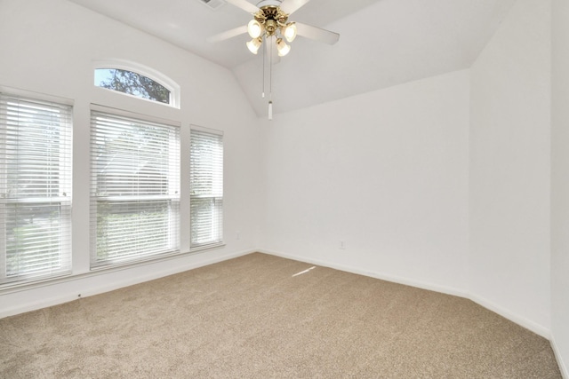 carpeted empty room with ceiling fan and lofted ceiling