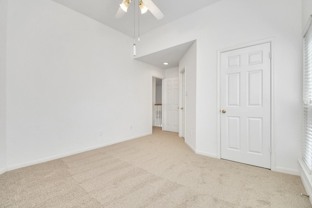 unfurnished bedroom with light carpet and ceiling fan