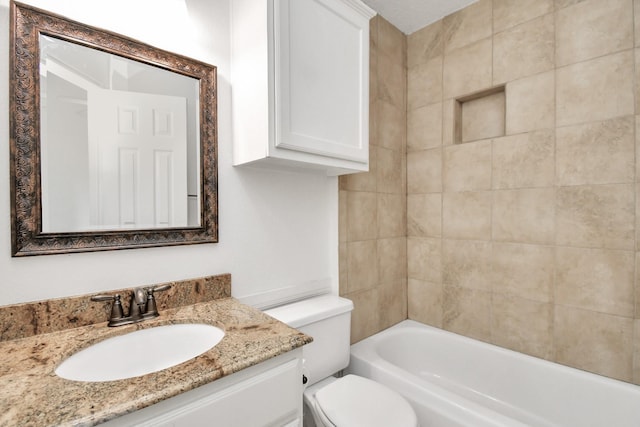 full bathroom with vanity, toilet, and tiled shower / bath