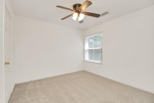 unfurnished room featuring light carpet and ceiling fan