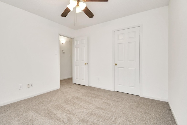 unfurnished bedroom with ceiling fan and light colored carpet