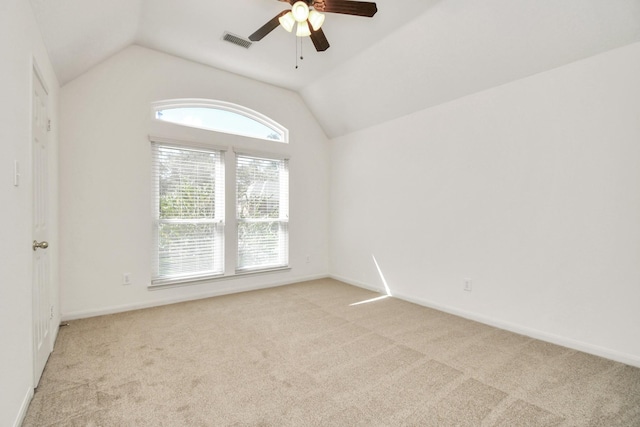 carpeted empty room with ceiling fan and lofted ceiling