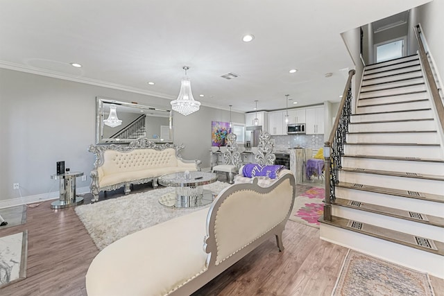 living room with hardwood / wood-style flooring and ornamental molding