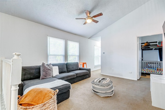 living room with a textured ceiling, light carpet, ceiling fan, and lofted ceiling