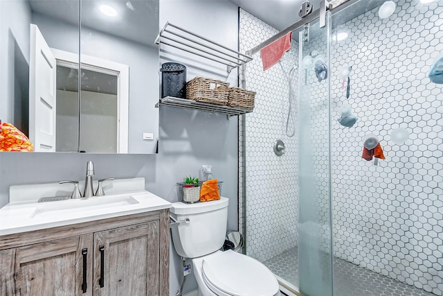 bathroom with vanity, toilet, and walk in shower