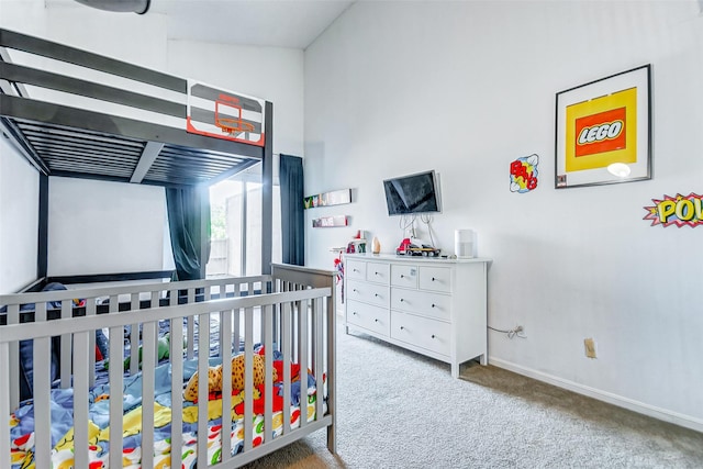 carpeted bedroom with lofted ceiling and a crib