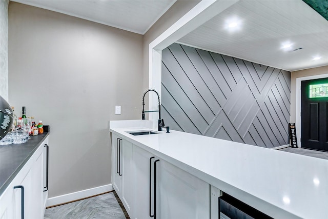 laundry area featuring sink and light parquet flooring