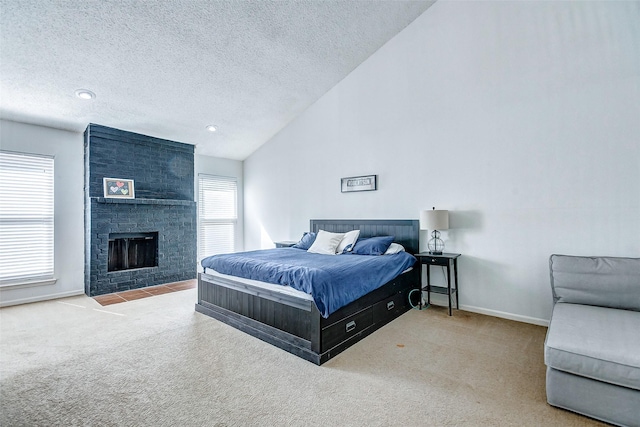 bedroom with a textured ceiling, carpet flooring, a fireplace, and vaulted ceiling