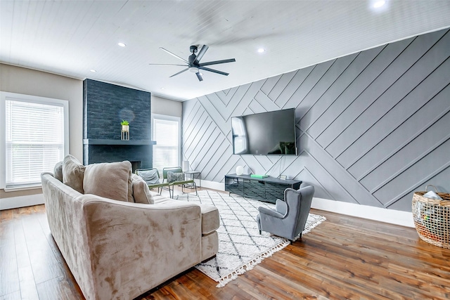 living room featuring hardwood / wood-style floors, a healthy amount of sunlight, and wooden walls