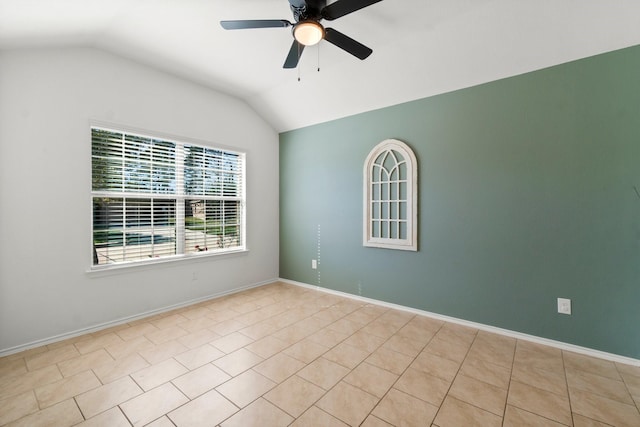 tiled empty room with ceiling fan and lofted ceiling