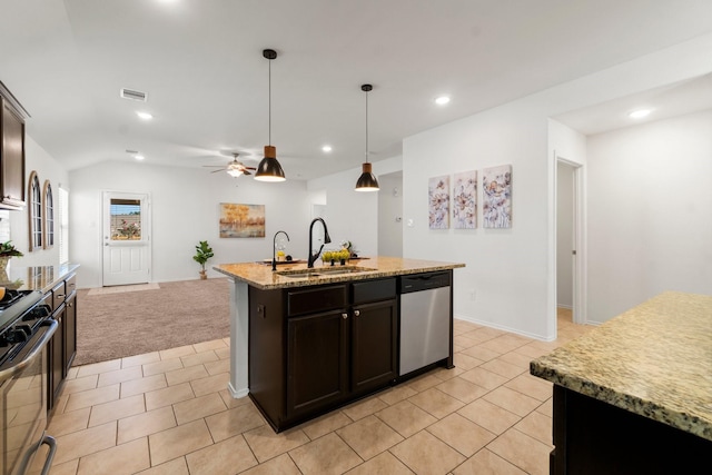 kitchen featuring ceiling fan, sink, hanging light fixtures, a kitchen island with sink, and appliances with stainless steel finishes